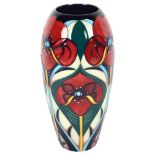 A Moorcroft tube-lined baluster vase, with stylised poppy decoration, 18.5cm