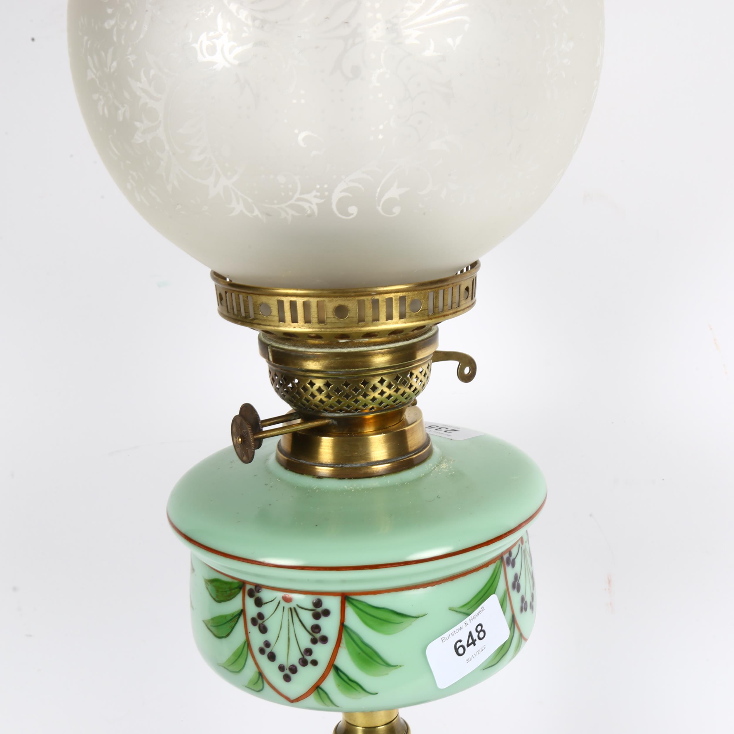 A Victorian brass oil lamp, with a cranberry and clear glass etched shade and painted green glass - Image 2 of 2