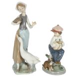 A Lladro boy with puppy, and a Lladro girl with duck, height 23cm