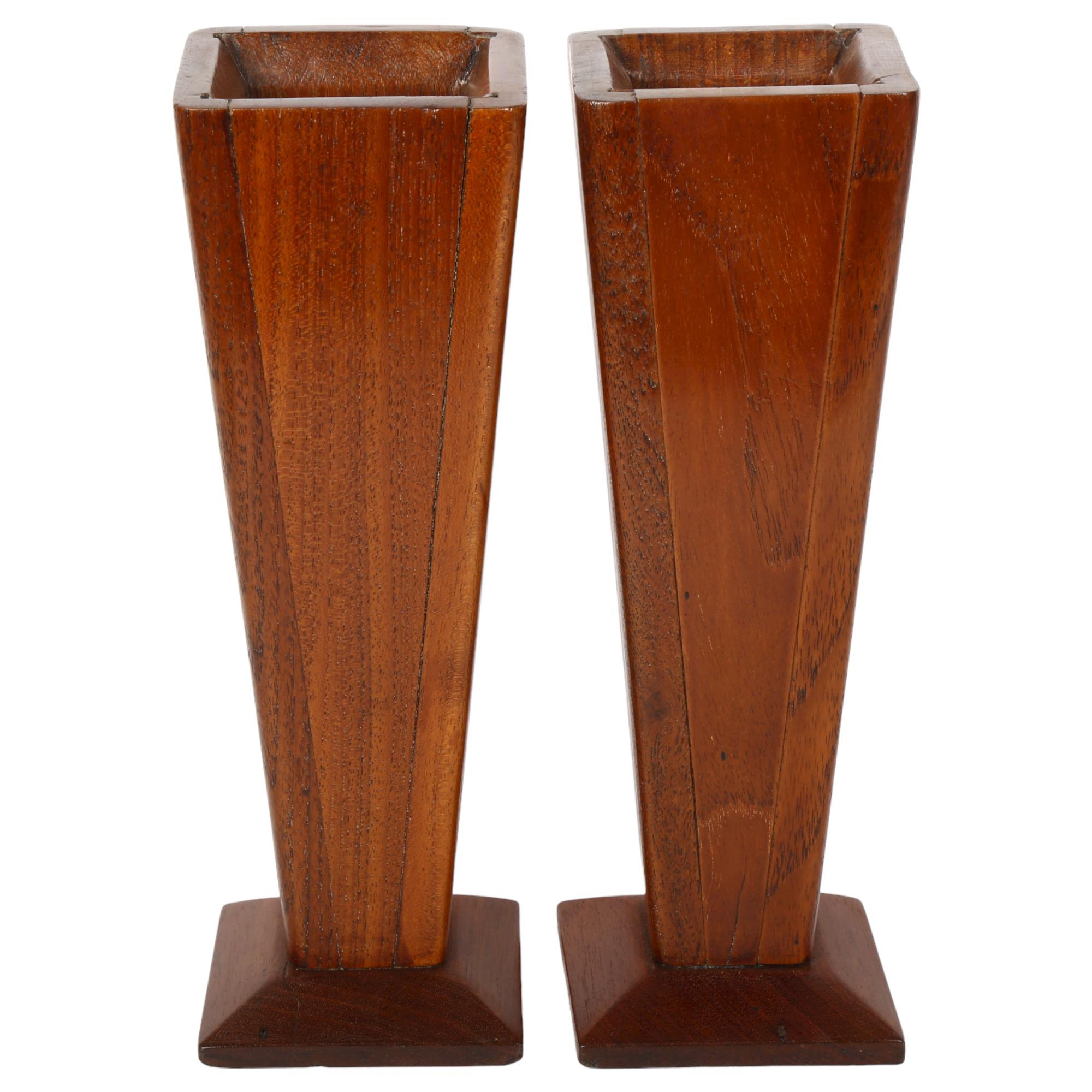 A pair of Arts and Crafts style mahogany vases of tapered form, height 27cm