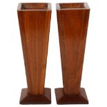 A pair of Arts and Crafts style mahogany vases of tapered form, height 27cm