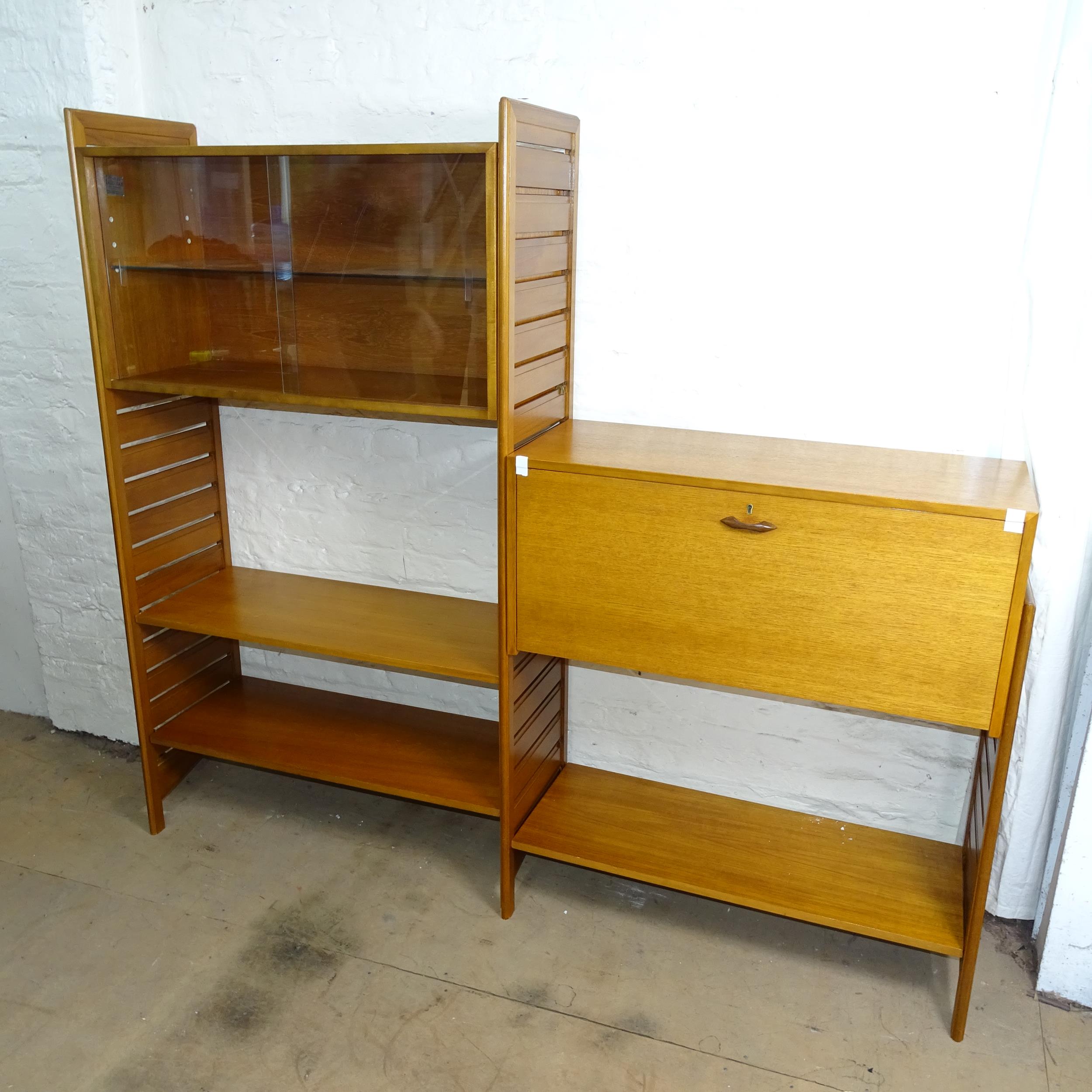 A mid-century teak Staple's ladderax modular system comprising of bureau desk, glazed cabinet and