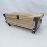 A contemporary pine storage box / low coffee table with lifting lid, raised on casters. 83cm x