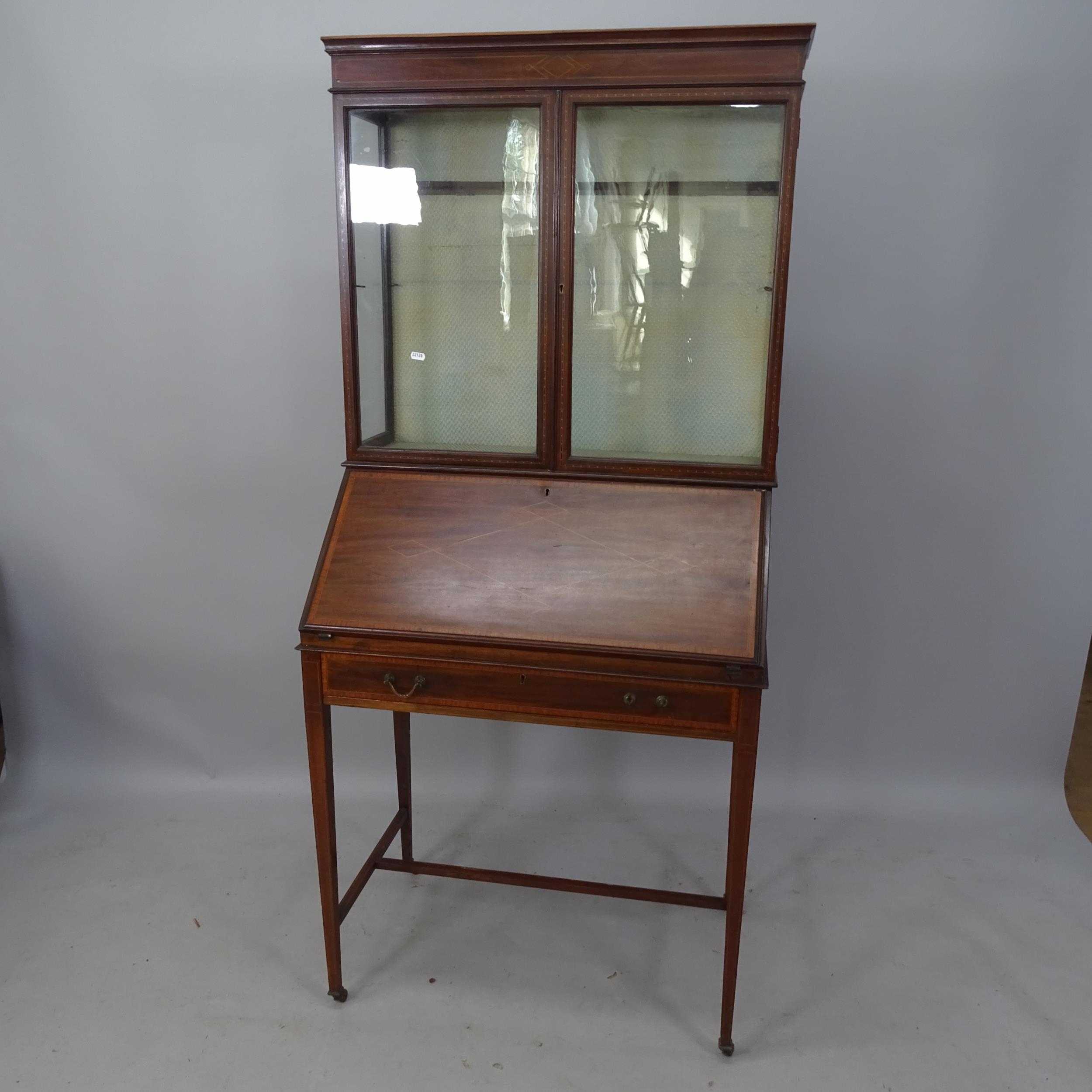 An Edwardian mahogany and satinwood-strung 2-section bureau bookcase, the fall-front revealing a