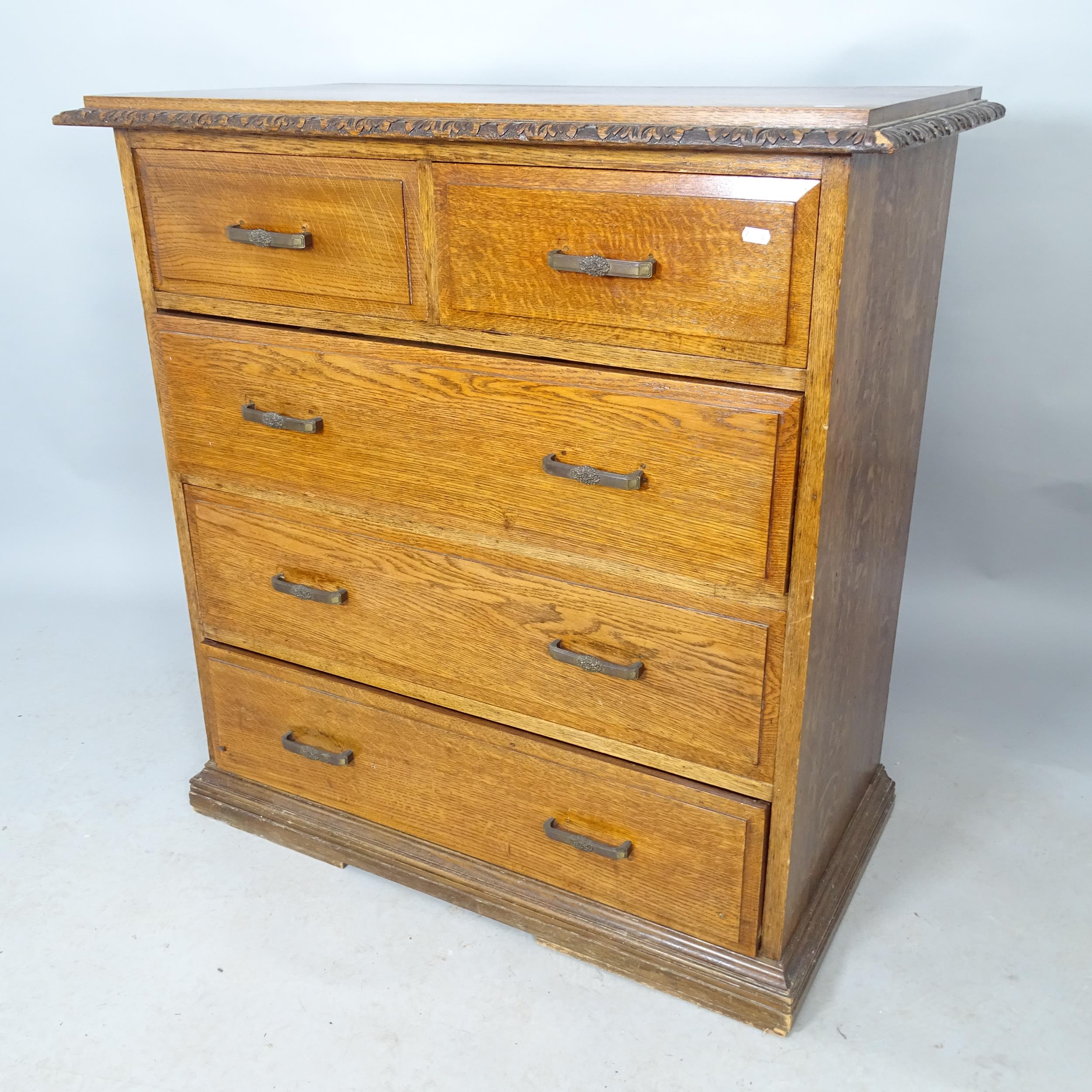 An early 20th century oak chest of 2 short and 3 long drawers, with carved decoration, 98 x 101 x