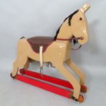 A painted wooden rocking horse. L 100cm