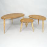 A mid-century Ercol elm nest of three pebble occasional tables, largest 66cm x 41cm x 45cm