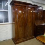 A Victorian mahogany linen press, with drawer and slide fitted interior and detachable base and