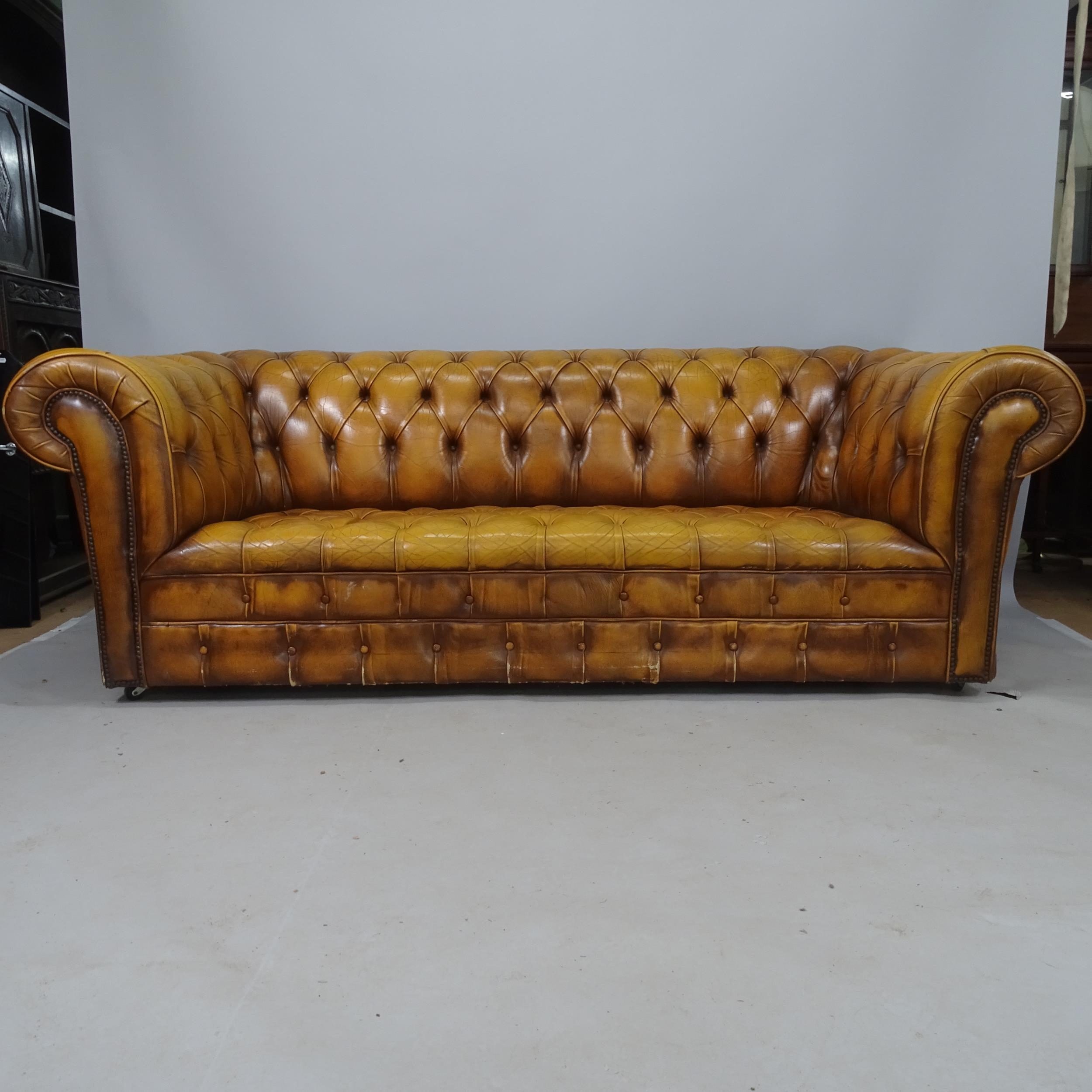 A buttoned brown leather-upholstered Chesterfield sofa, 200 x 80 x 85cm