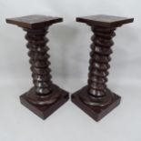 A pair of French stained elm spiral turned columns, Height 86cm