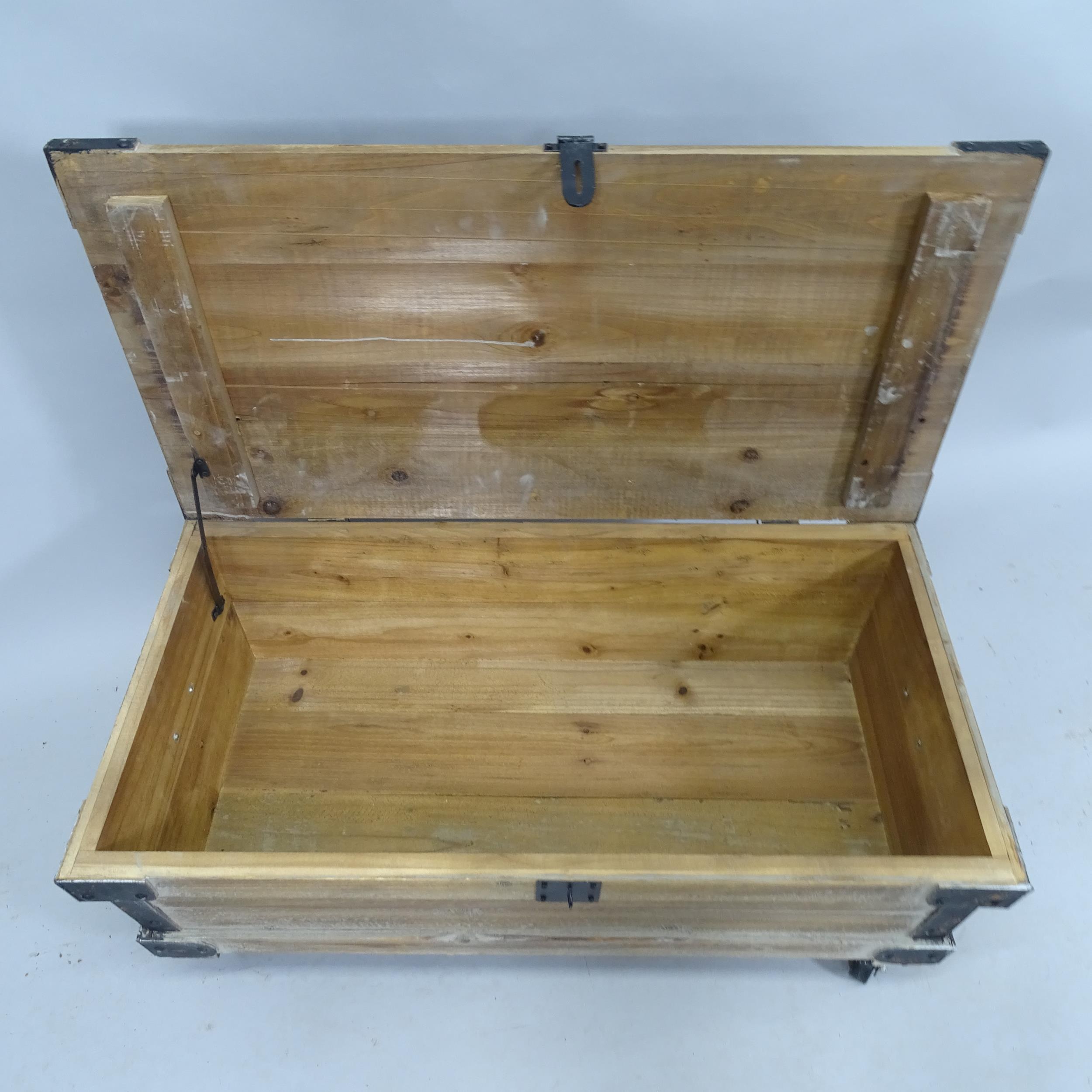 A contemporary pine storage box / low coffee table with lifting lid, raised on casters. 83cm x - Image 2 of 2