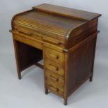 A 1930s single pedestal tambour front roll top desk, 93cm x 99cm x 71cm (with key)