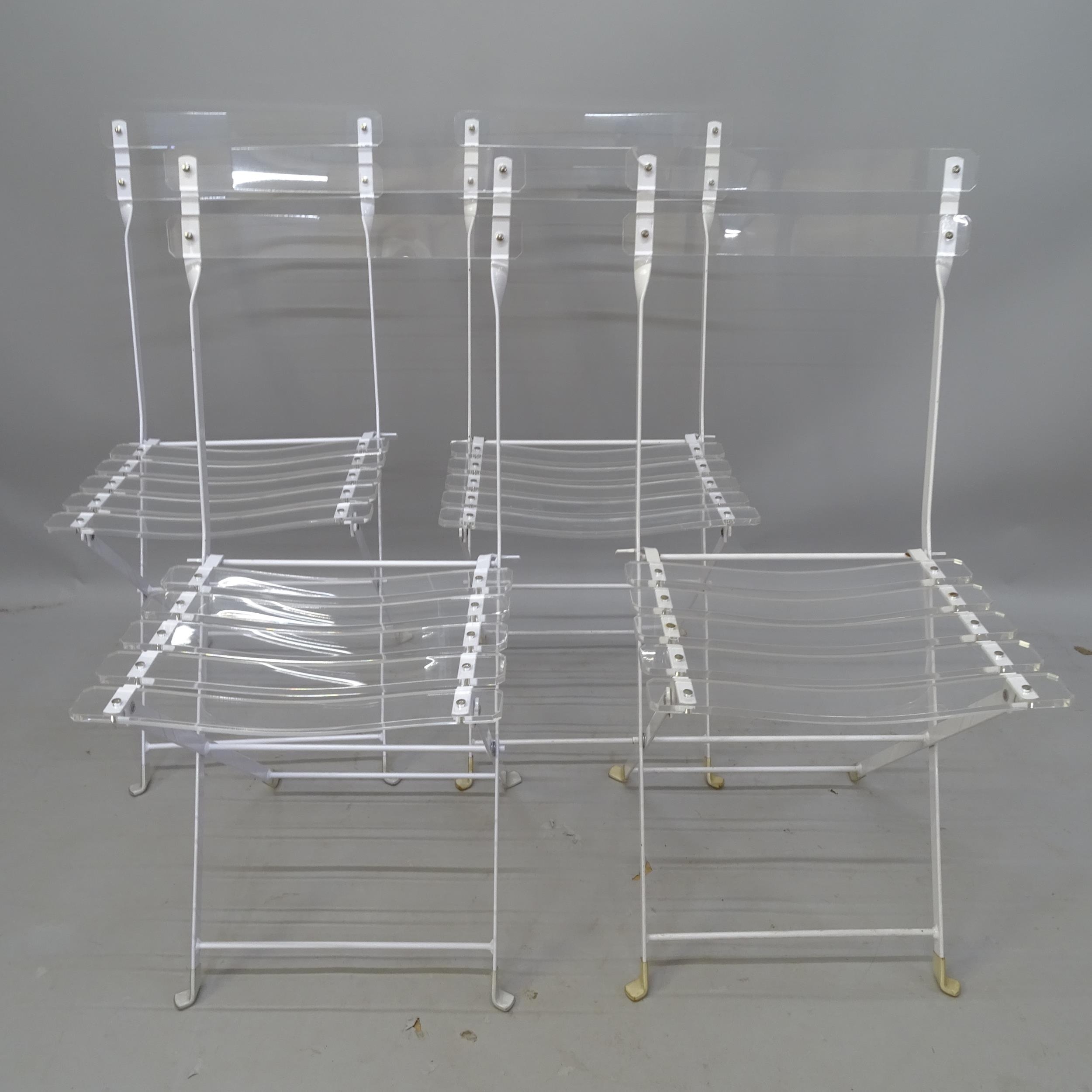 A set of 4 lucite and white enamelled steel folding bistro style chair