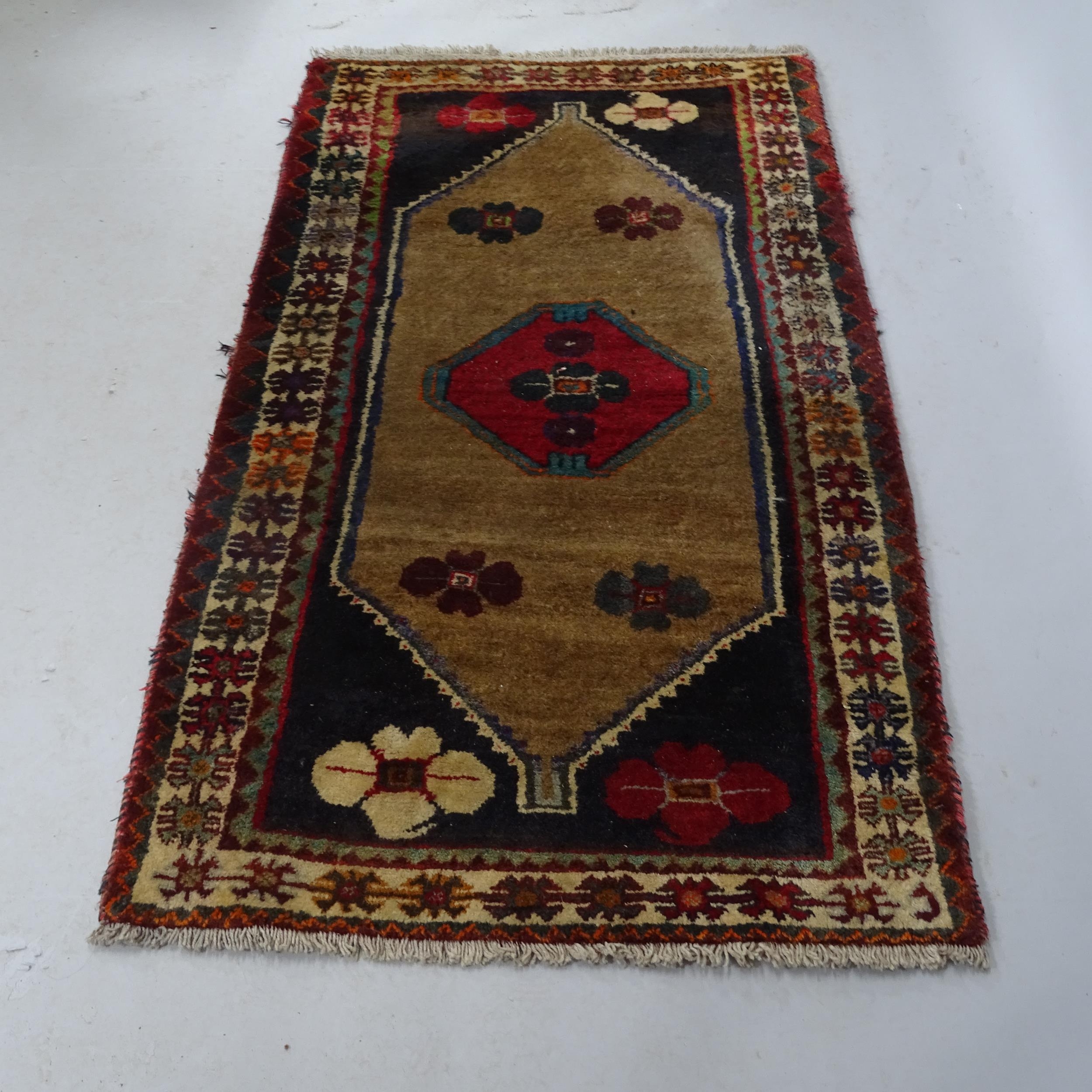 A red-ground Persian design rug. 160cm x 90cm