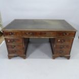 An Edwardian mahogany twin-pedestal writing desk, with inset tooled leather skiver and 9 fitted