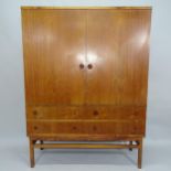 A Mid-century Danish rosewood drinks cabinet, the oask lined interior fitted with drawers and