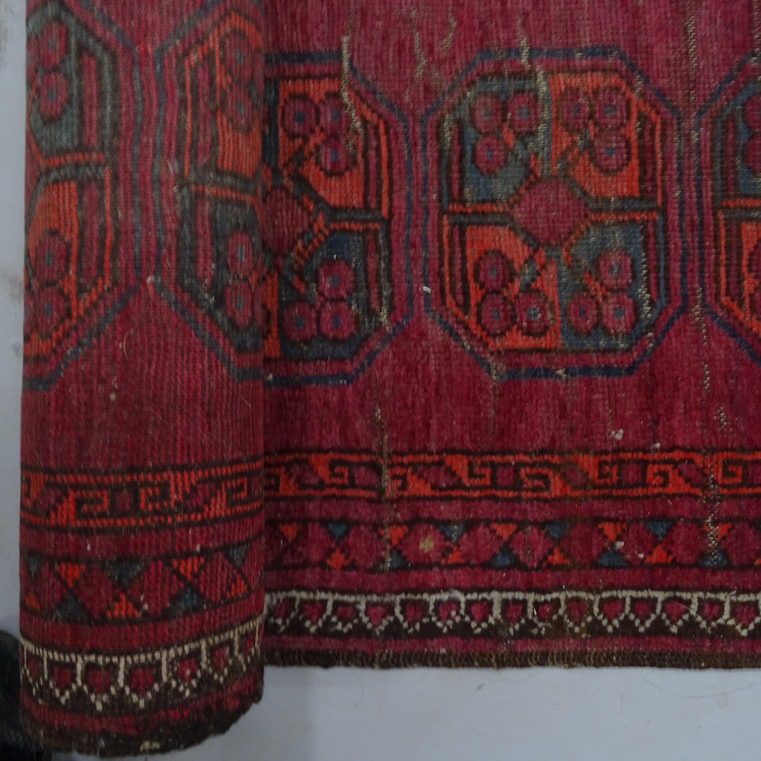 A red ground Turkish runner, 285 x 90cm There is an oval 20cm visible patch repair, other smaller - Image 2 of 2