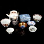A group of Oriental items, including porcelain tea bowls, unmarked white metal snuff bottle,
