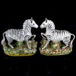 A pair of Staffordshire pottery zebra figures, height 19.5cm One zebra has an ear and hoof