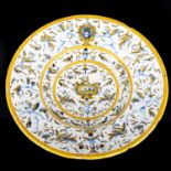 An Italian Maiolica faience bowl, tin glaze earthenware pottery with hand painted cherub decoration,