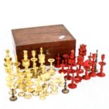 A collection of 19th century red and white stained ivory chessmen from various sets, in a Jacques