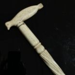 A 19th century narwhal tusk walking stick, with a carved seal handle and twisted stem, length