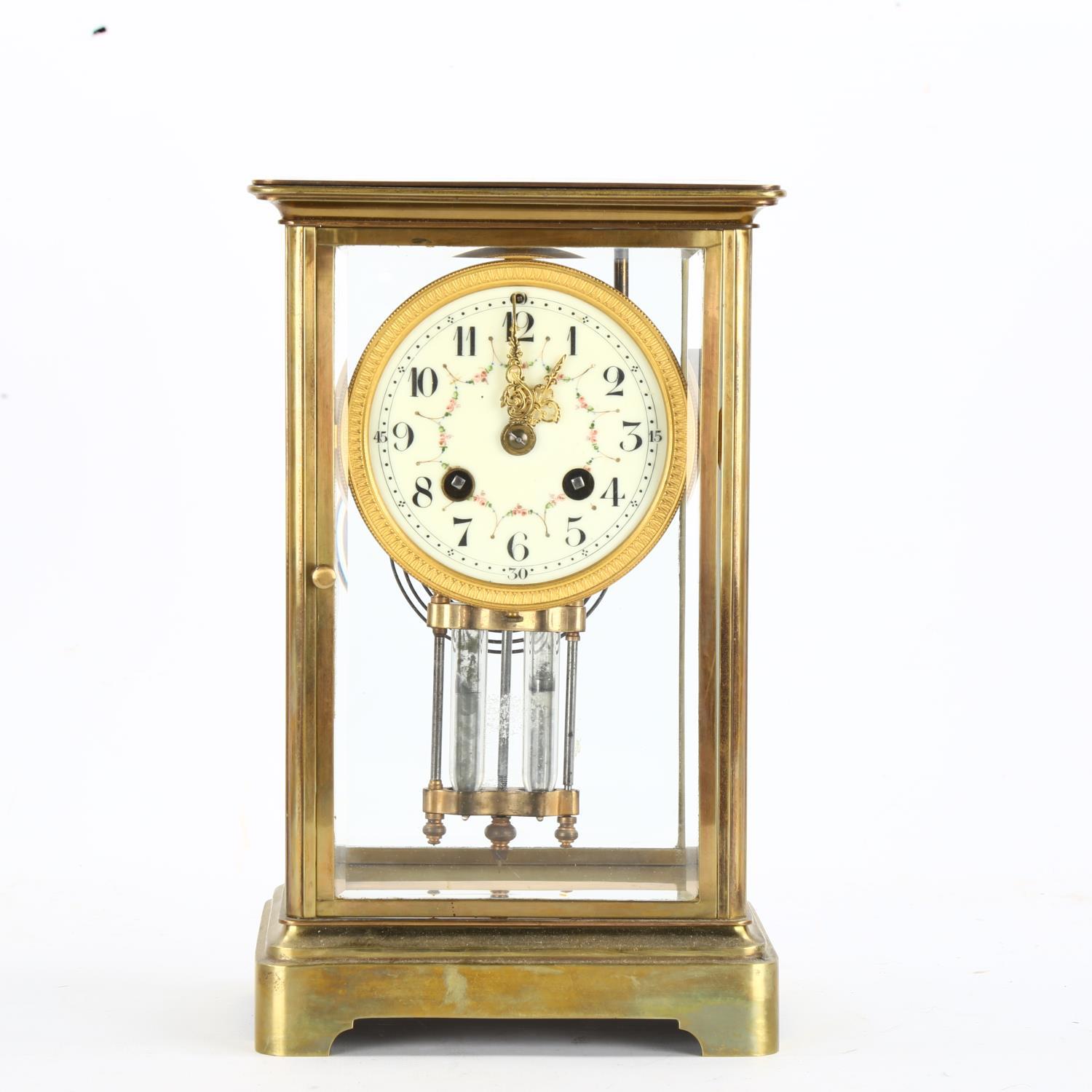 An early 20th century brass 4-glass 8-day mantel clock, hand painted white enamel dial with Arabic