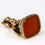 An Antique carnelian seal fob, unmarked yellow metal settings, with shell and floral lattice