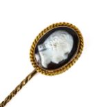 An Antique hardstone cameo stickpin, unmarked gold settings, with relief carved male head profile,