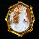 A Victorian shell cameo brooch, depicting Classical female profile with roses, in unmarked yellow