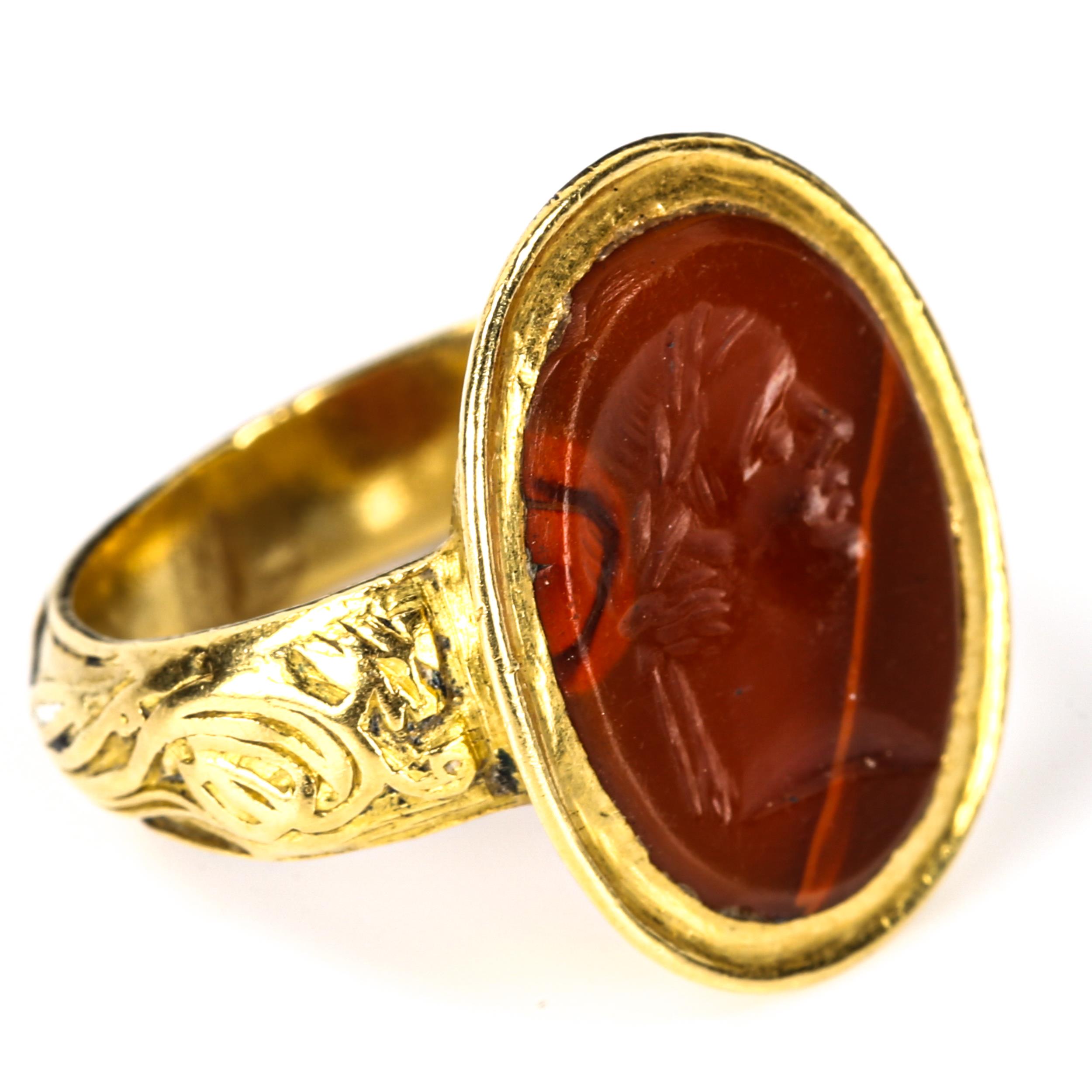An Antique hardstone seal ring, heavy unmarked high carat gold settings, with intaglio carved male - Image 3 of 5
