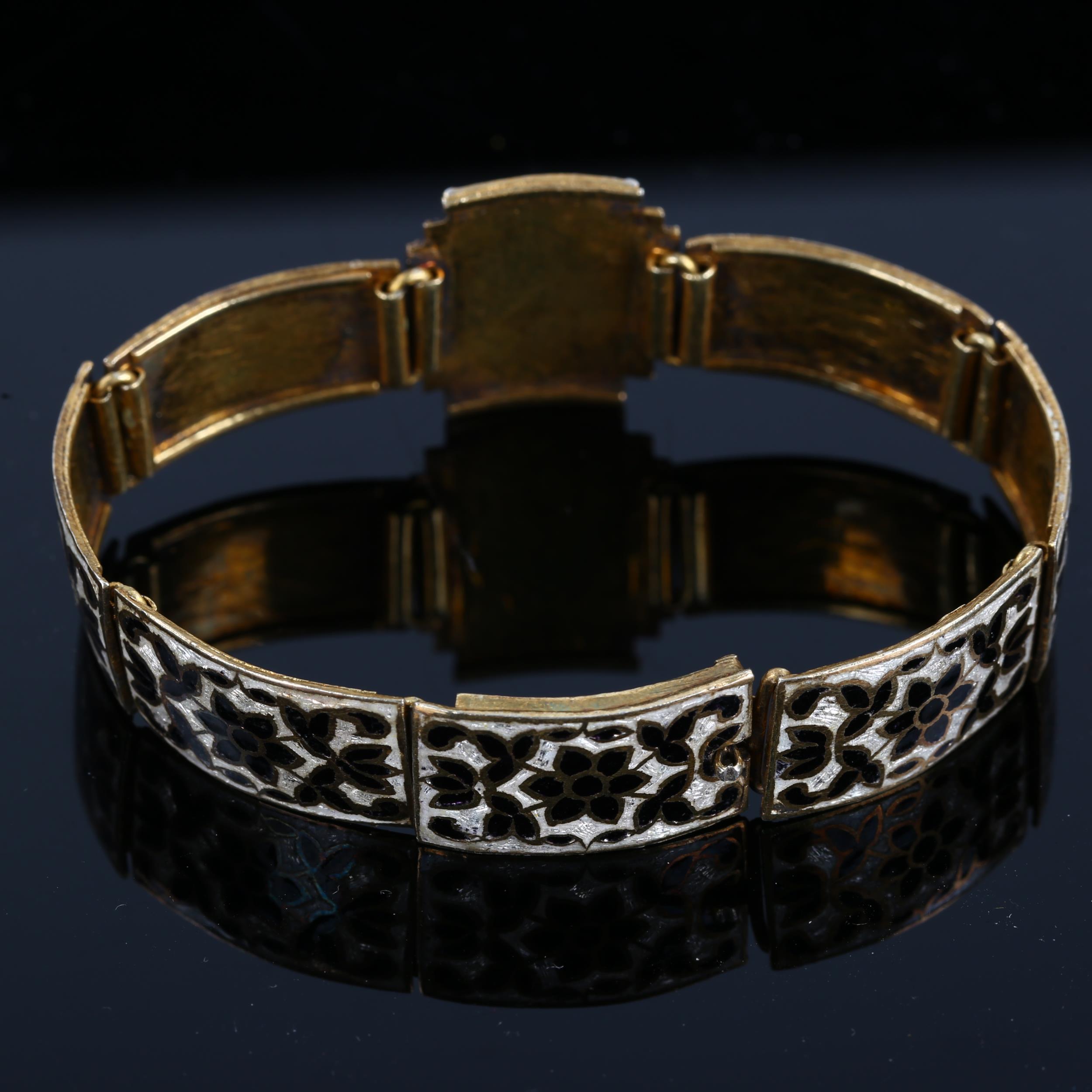 A gilded black and white enamel panel bracelet, unmarked, length 16cm, 17.3g General surface wear