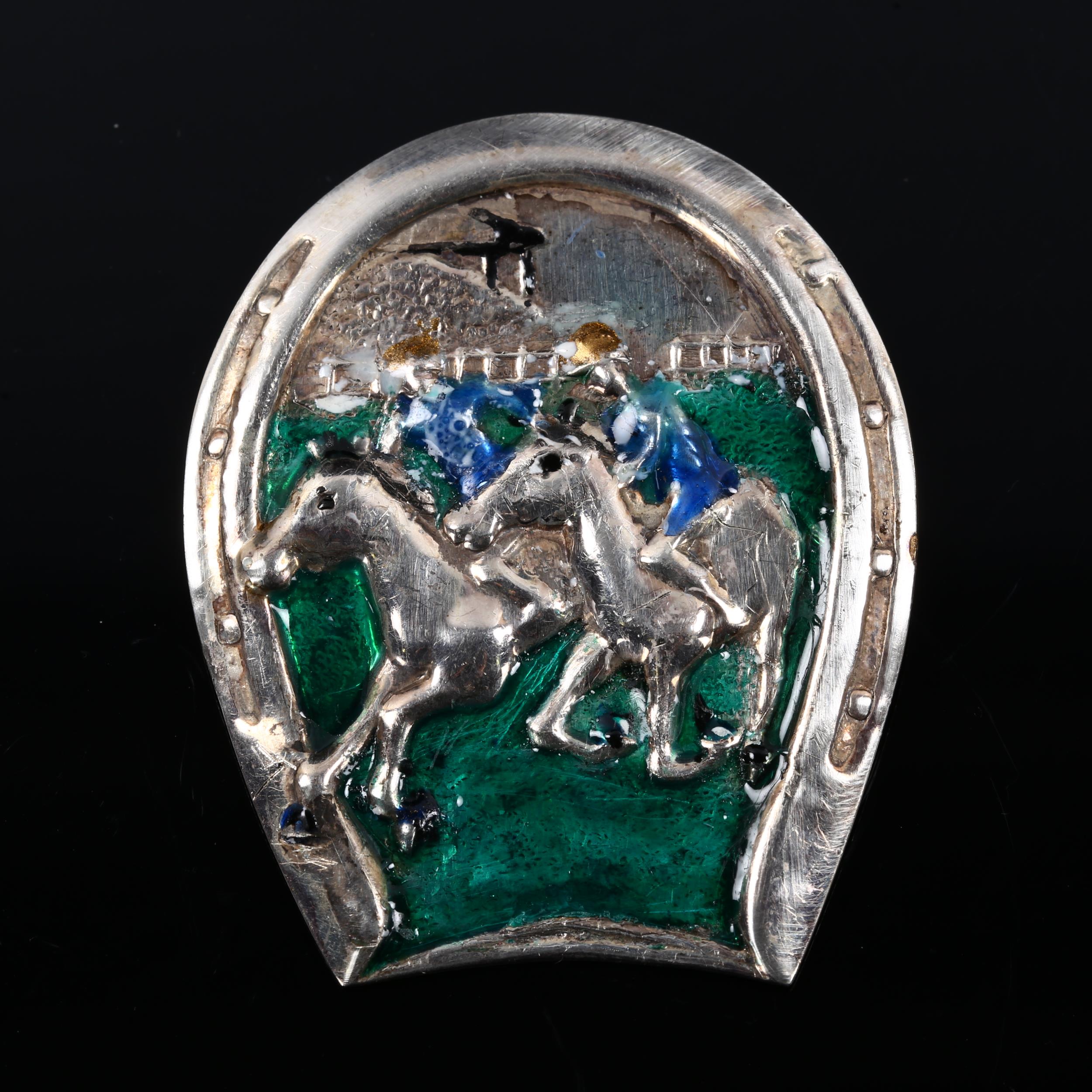 A large Continental sterling silver and enamel horse racing brooch, height 61.2mm, 23.4g A few minor