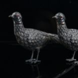 A pair of Continental silver table pheasants, with cabochon red glass eyes, marks on tail