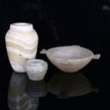 An early alabaster bowl with carved integral handles, diameter excluding handles 12cm, an early
