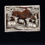 A 19th century Bavarian staghorn brooch, with relief carved design of stags in woodland, 6cm x 4.5cm