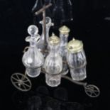 A Victorian novelty 5-bottle cruet set, modelled as a tricycle, original cut-glass bottles on