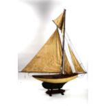 A large Vintage wood-hulled model pond yacht, with sails and rigging, on stand, total length