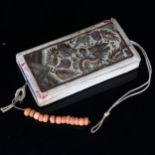 A Chinese embroidered silk case, containing a blue silk covered notebook and a short string of coral