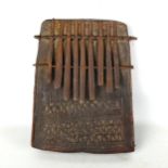 An early African Tribal piano, chip carved wood and metal, length 23cm Carving is slightly worn