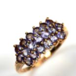 A modern 9ct gold tanzanite cluster ring, set with round-cut tanzanites, setting height 10.1mm, size