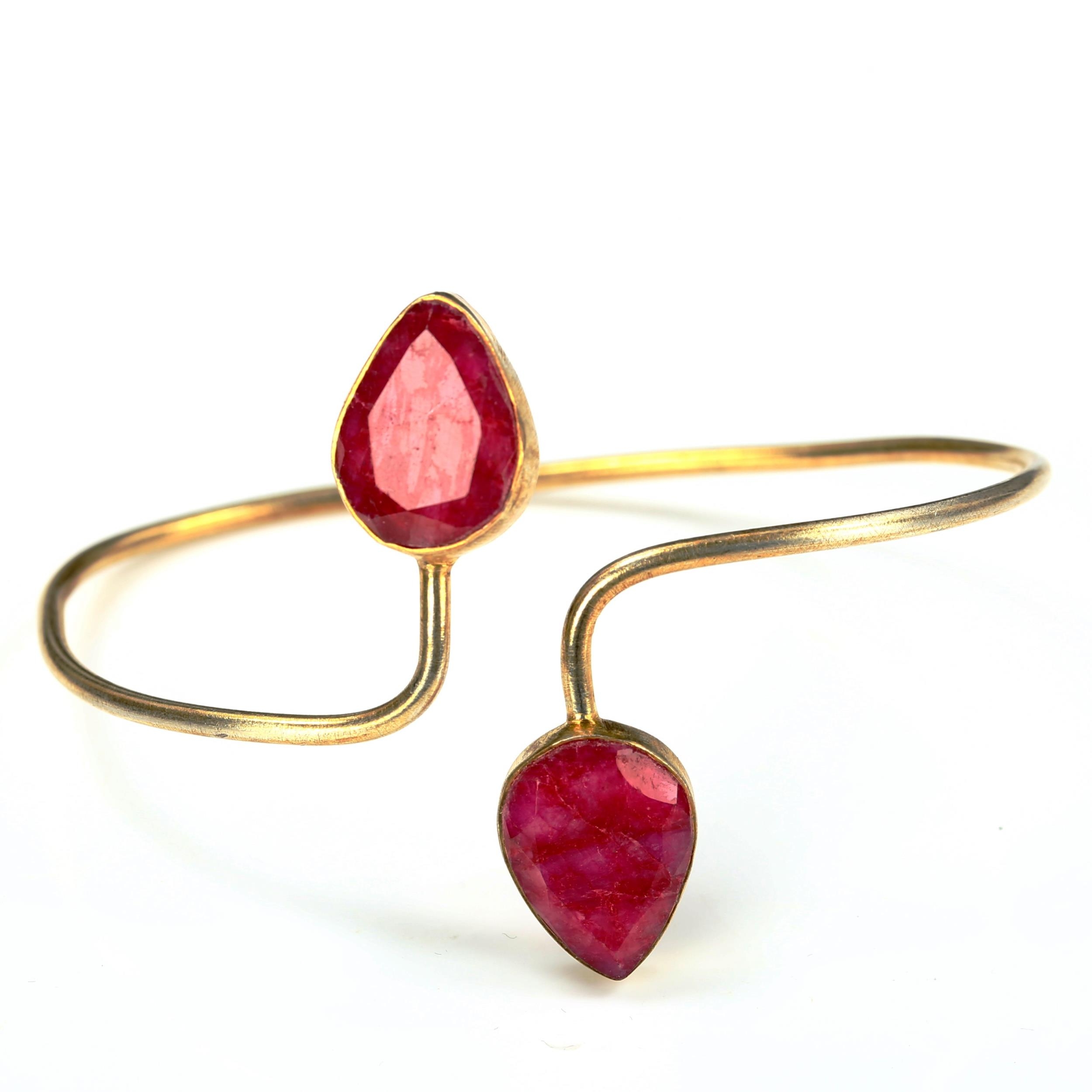 A modern unmarked silver-gilt ruby torque bangle, internal measurements 6.5cm x 5cm, 12.1g No damage