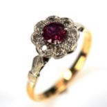 An 18ct gold ruby and diamond cluster ring, set with round-cut ruby and single-cut diamonds, setting