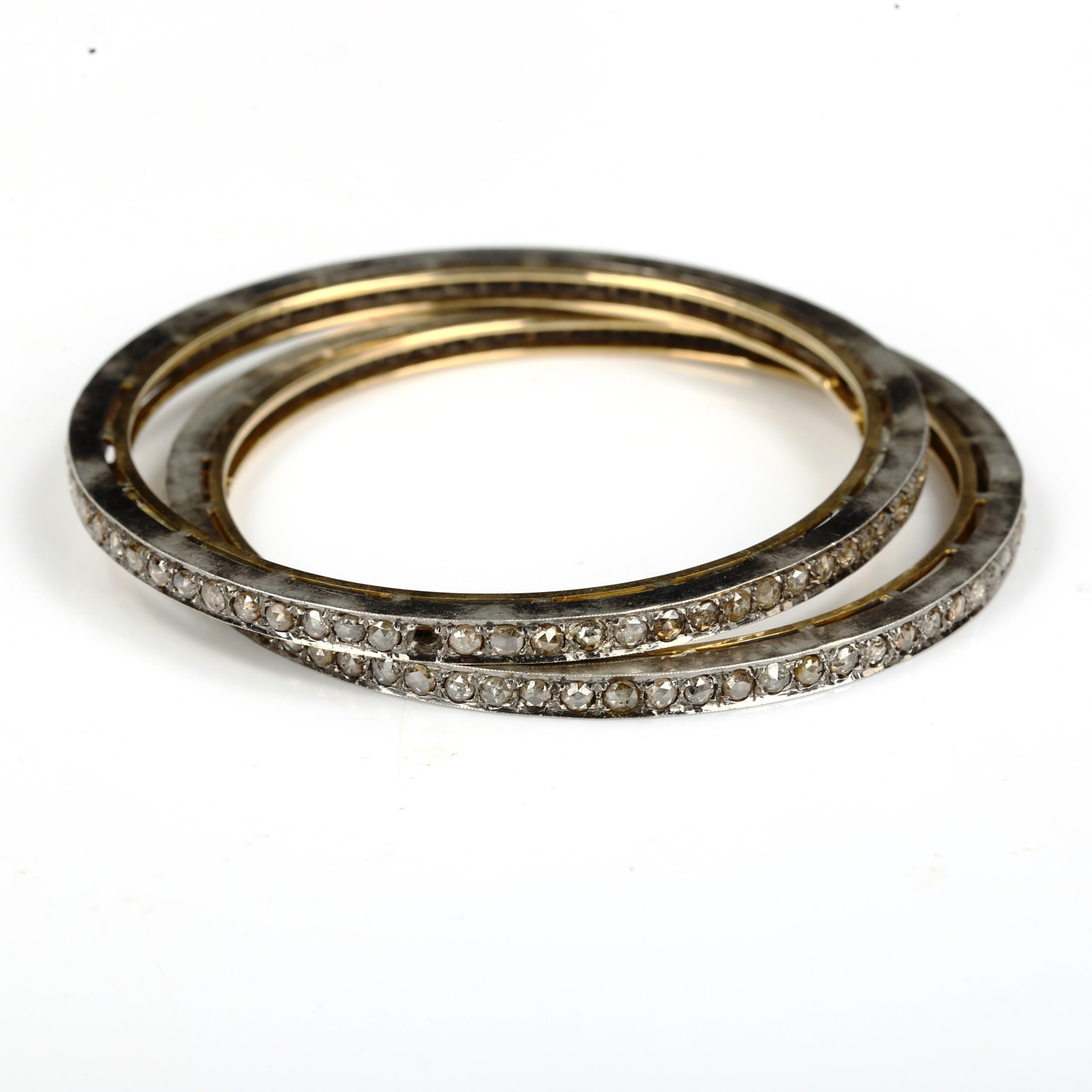 A pair of Indian silver on gold diamond slave bangles, set with rose-cut diamonds, band width 3.6mm,