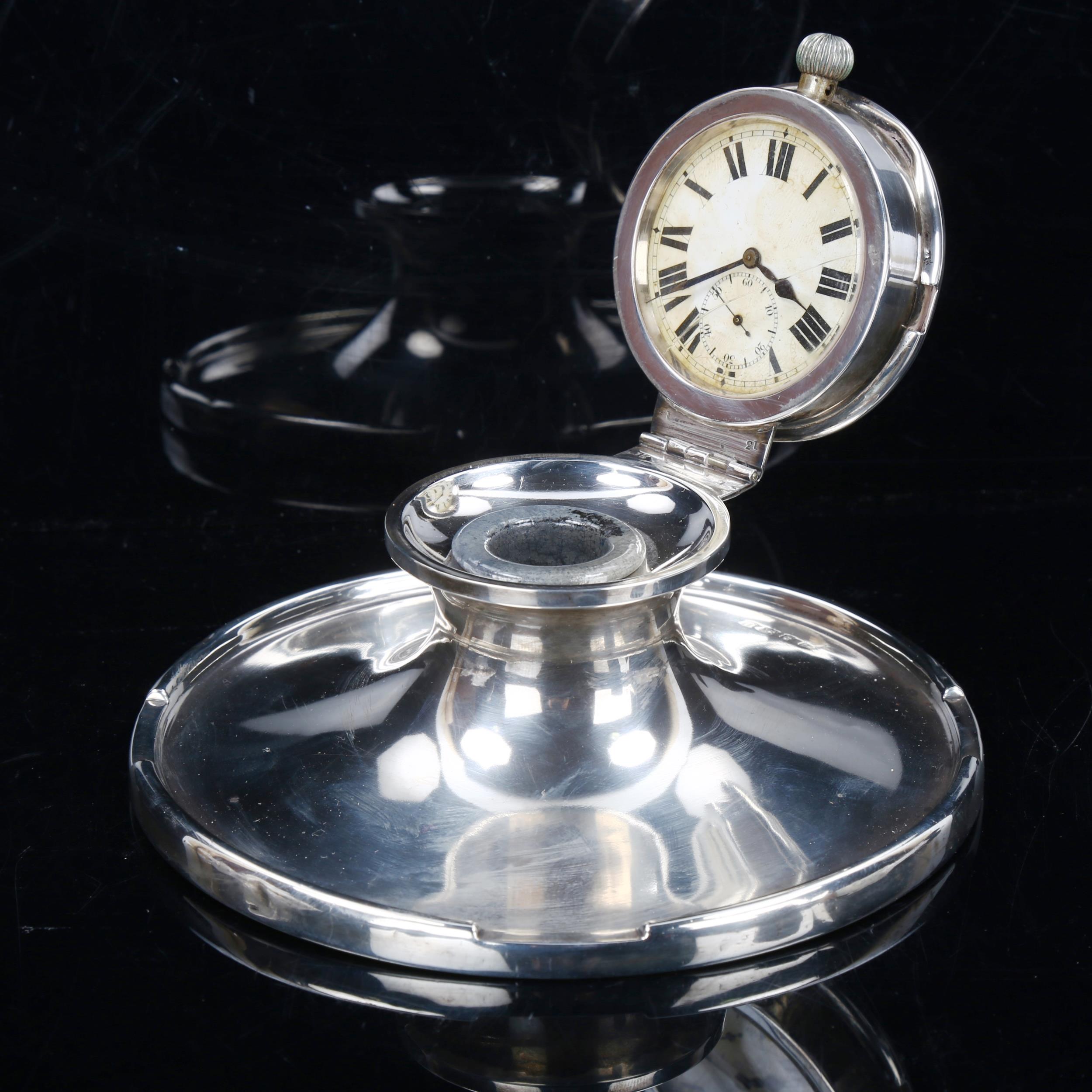 A George V silver-mounted pocket watch Capstan inkwell, with lid containing pocket watch movement