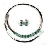 A modern 18ct white gold emerald and diamond matching necklace and earring set, set with oval