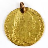 A George III 1775 gold guinea coin, fourth portrait with rose shield and pierced pendant loop, 8.3g