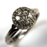 A modern 9ct white gold diamond cluster ring, set with modern round brilliant-cut diamonds, total