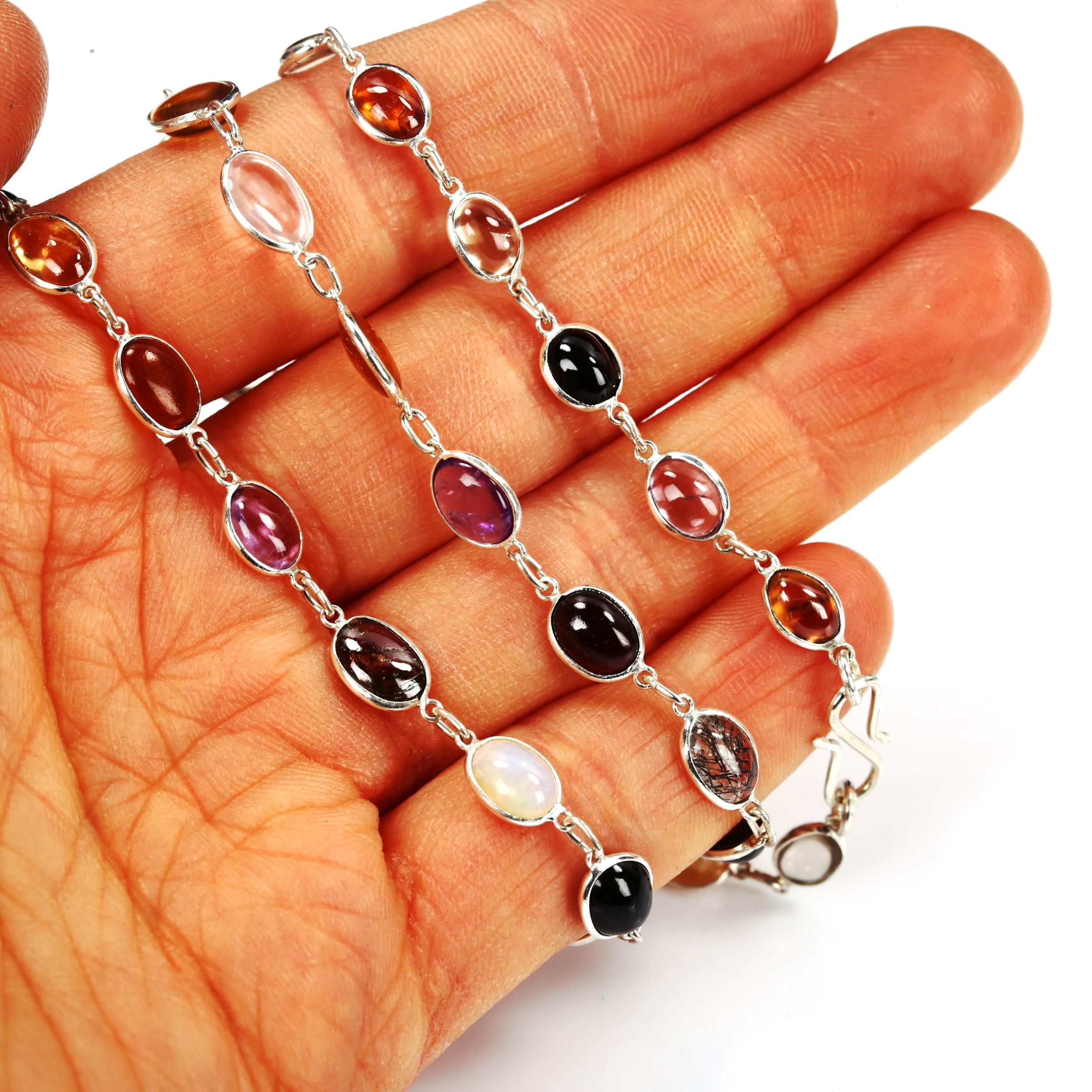 A modern sterling silver graduated gem set line necklace, set with oval cabochon gemstones, to - Image 4 of 4