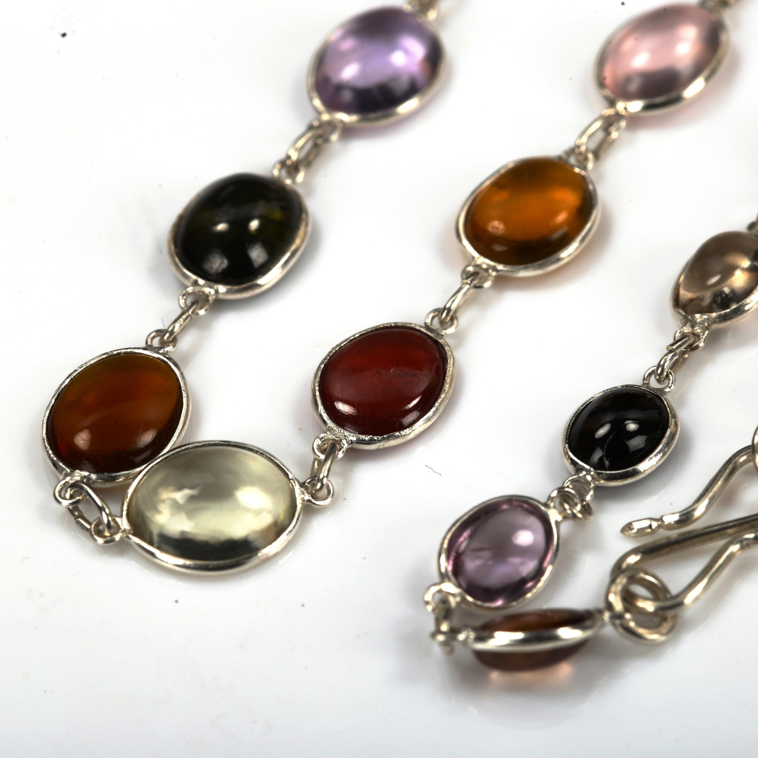 A modern sterling silver graduated gem set line necklace, set with oval cabochon gemstones, to - Image 3 of 4
